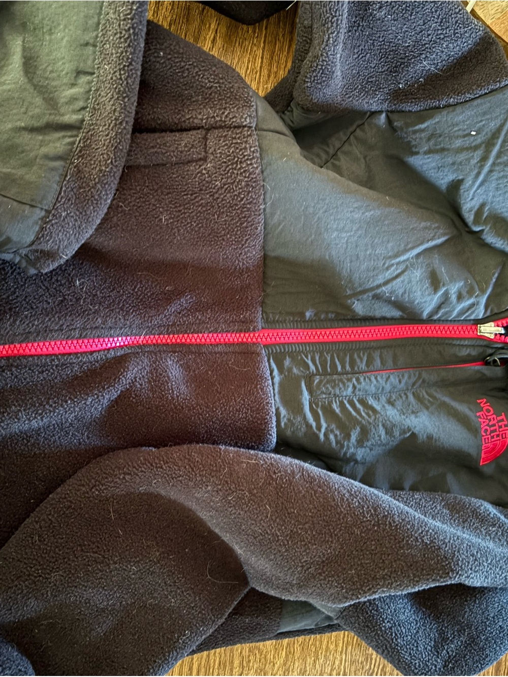 The North Face women’s Black Fleece Jacket with Pink Accents